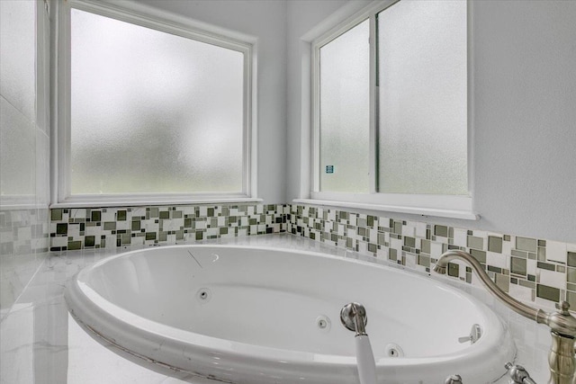 bathroom featuring tiled tub