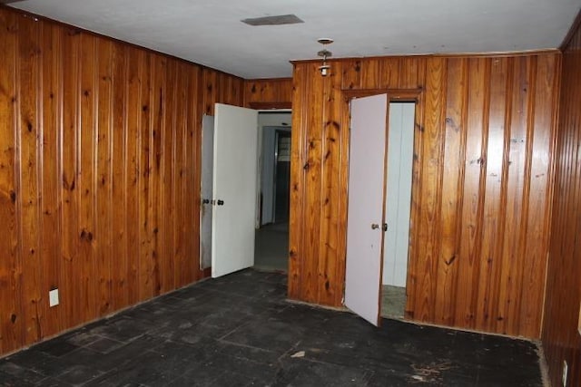 spare room featuring wooden walls