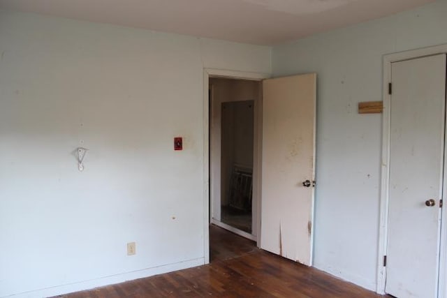 unfurnished bedroom featuring baseboards and wood finished floors