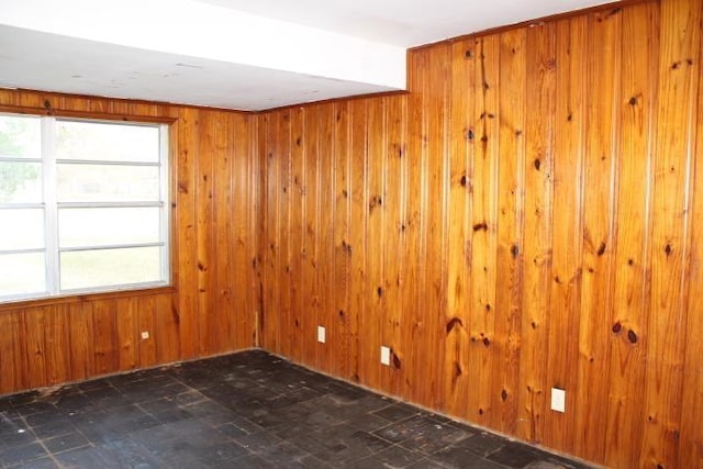 empty room featuring wood walls