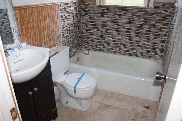 bathroom featuring toilet, tile patterned floors, shower / bath combination, and vanity