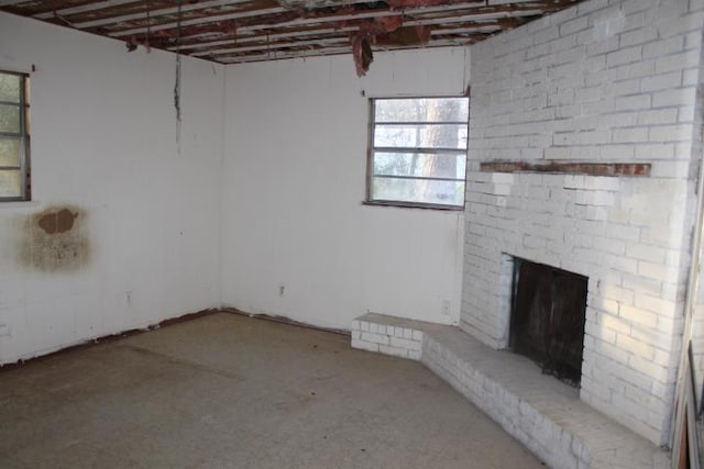 interior space featuring a fireplace and unfinished concrete floors