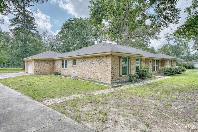 246 Pinevale Way, Sour Lake, TX 77659 - view of front facade featuring brick siding, a garage, a front lawn, driveway, and a shingled roof