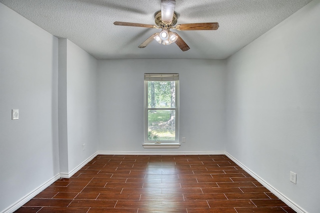 246 Pinevale Way, Sour Lake, TX 77659 - spare room featuring a ceiling fan, a textured ceiling, dark wood-style flooring, and baseboards