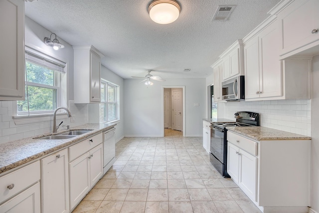 246 Pinevale Way, Sour Lake, TX 77659 - kitchen featuring electric range, stainless steel microwave, dishwasher, a sink, and backsplash