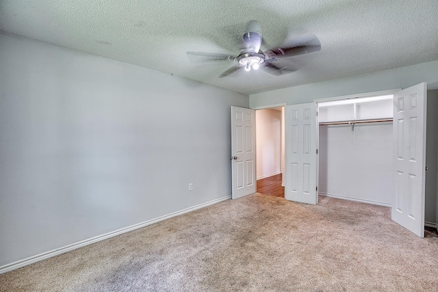 246 Pinevale Way, Sour Lake, TX 77659 - unfurnished bedroom with carpet, a closet, ceiling fan, baseboards, and a textured ceiling
