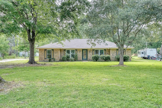 246 Pinevale Way, Sour Lake, TX 77659 - ranch-style home featuring a front lawn, brick siding, and roof with shingles