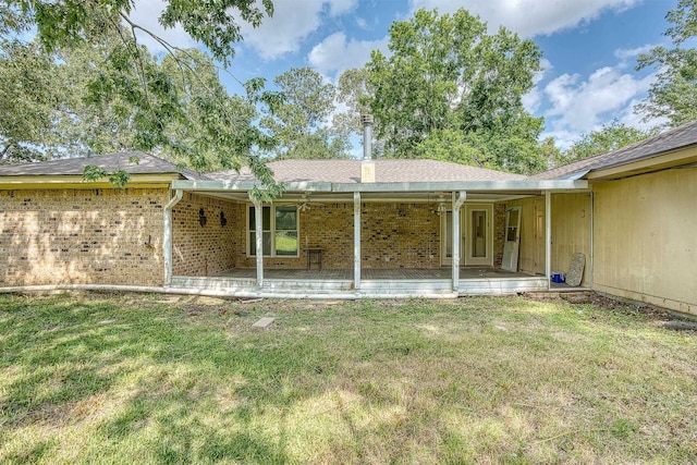 246 Pinevale Way, Sour Lake, TX 77659 - rear view of house featuring a yard, brick siding, and roof with shingles