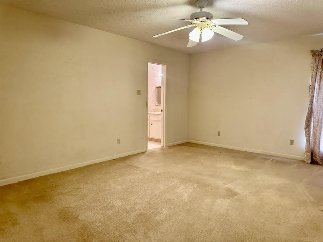 carpeted spare room featuring ceiling fan and a textured ceiling