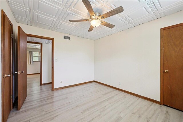 2701 Mcbride Dr, Port Neches, TX 77651 - unfurnished room featuring light wood finished floors, ceiling fan, and an ornate ceiling