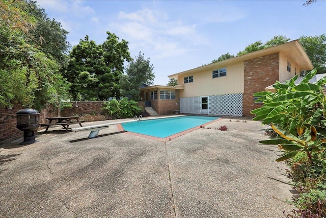 2701 Mcbride Dr, Port Neches, TX 77651 - view of swimming pool featuring a patio area, grilling area, and a diving board