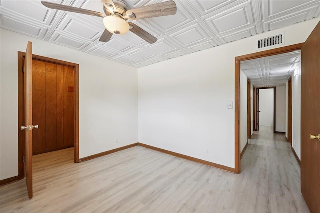 2701 Mcbride Dr, Port Neches, TX 77651 - unfurnished room with light wood-style floors, a ceiling fan, and an ornate ceiling
