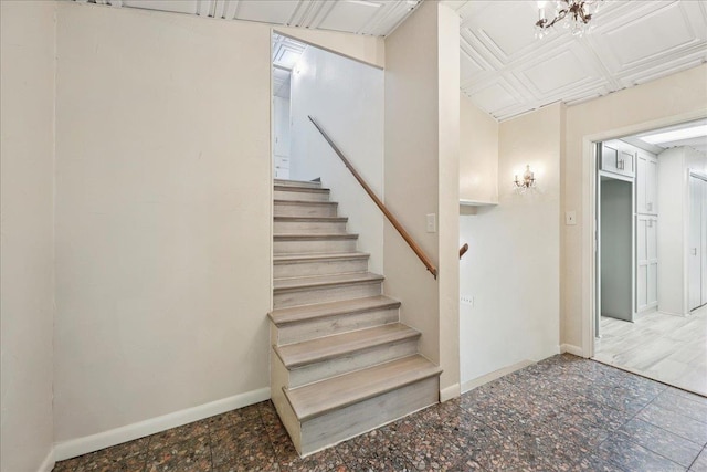 2701 Mcbride Dr, Port Neches, TX 77651 - staircase featuring baseboards and a chandelier