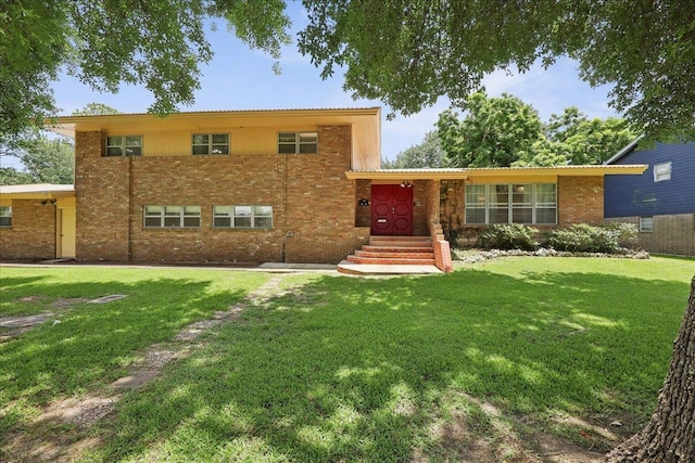 2701 Mcbride Dr, Port Neches, TX 77651 - tri-level home with brick siding and a front yard