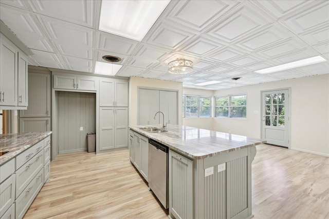 2701 Mcbride Dr, Port Neches, TX 77651 - kitchen with dishwasher, light wood-type flooring, an island with sink, light stone countertops, and an ornate ceiling