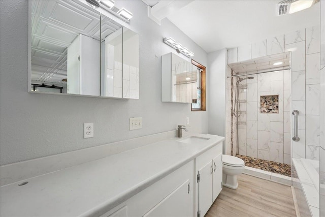 2701 Mcbride Dr, Port Neches, TX 77651 - full bathroom featuring a stall shower, vanity, wood finished floors, and a textured wall