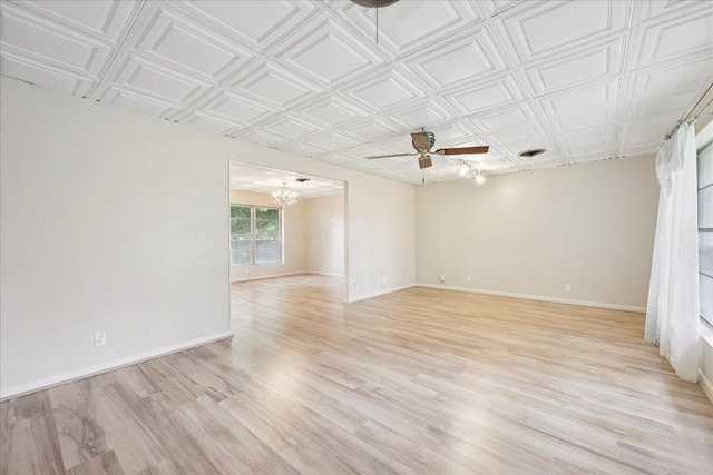 2701 Mcbride Dr, Port Neches, TX 77651 - spare room featuring a chandelier, a ceiling fan, light wood-type flooring, and an ornate ceiling