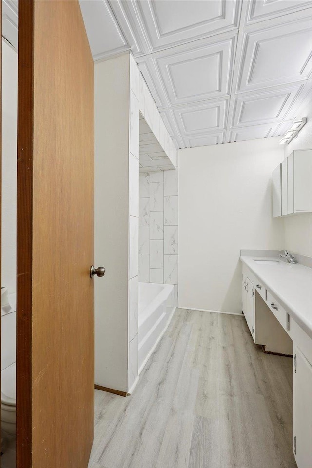 2701 Mcbride Dr, Port Neches, TX 77651 - bathroom featuring vanity, wood finished floors, and an ornate ceiling