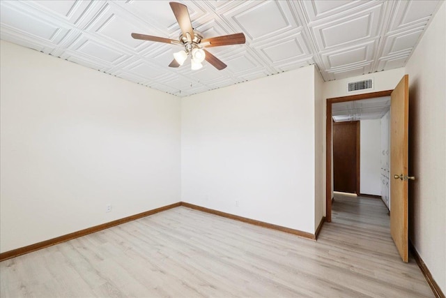 2701 Mcbride Dr, Port Neches, TX 77651 - unfurnished room with light wood-style flooring, a ceiling fan, and an ornate ceiling