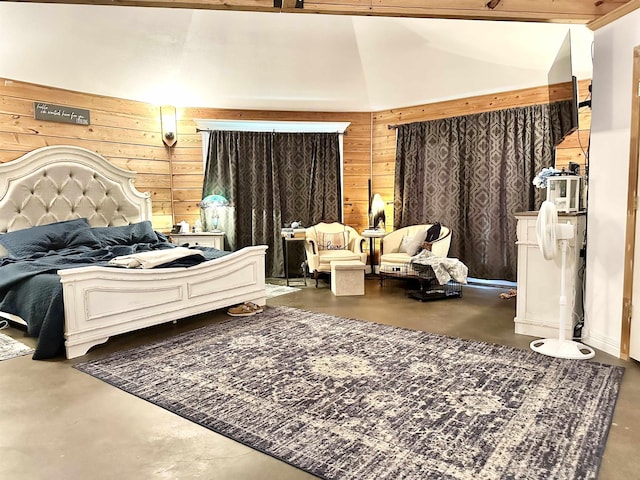 bedroom featuring finished concrete floors, wooden walls, and lofted ceiling