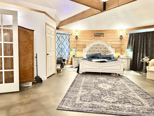 bedroom featuring baseboards, finished concrete flooring, wooden walls, and vaulted ceiling with beams