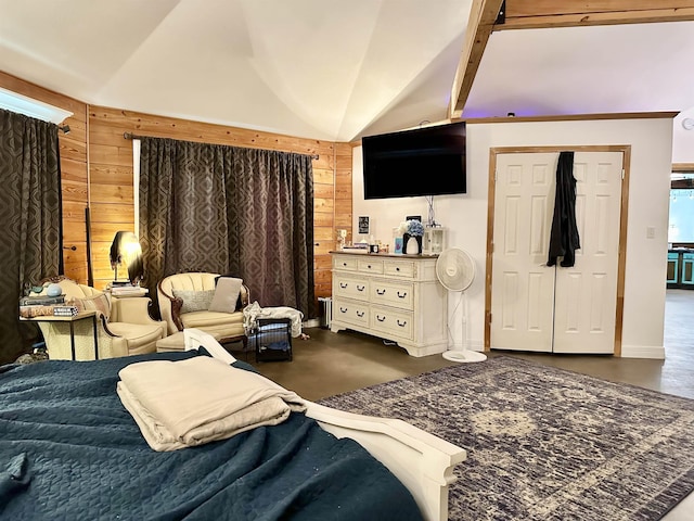bedroom with lofted ceiling, wooden walls, and finished concrete floors