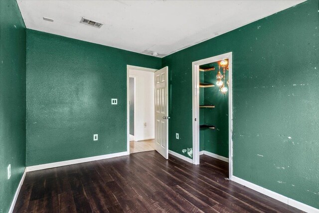 unfurnished bedroom featuring dark hardwood / wood-style floors