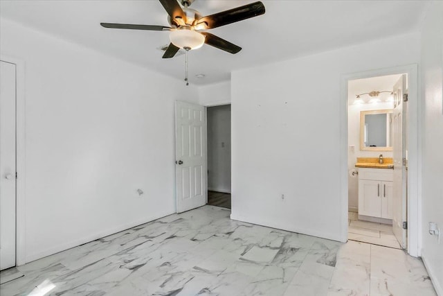 unfurnished bedroom featuring ensuite bathroom, ceiling fan, and sink