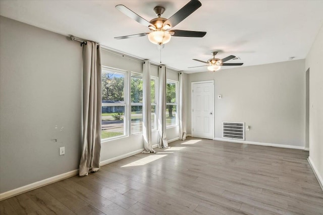 unfurnished room with ceiling fan and light hardwood / wood-style flooring