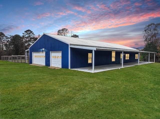 garage at dusk with a lawn