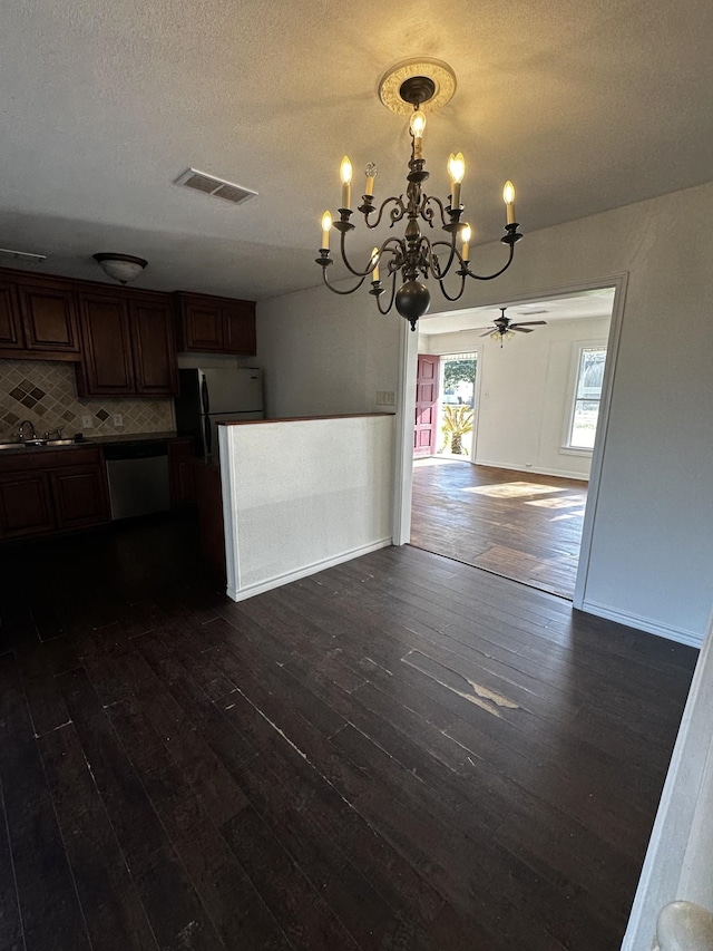 kitchen featuring visible vents, dishwasher, open floor plan, dark wood-style flooring, and freestanding refrigerator