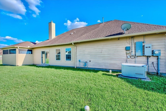 back of house with a lawn