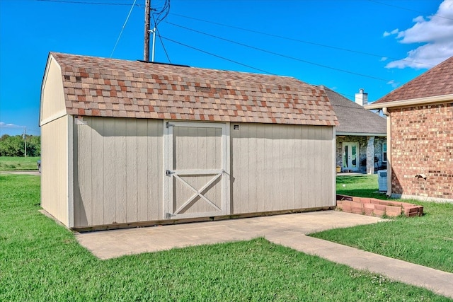 view of outbuilding with a lawn