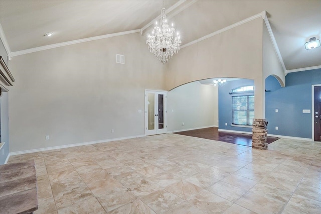 unfurnished living room with ornamental molding, high vaulted ceiling, and french doors