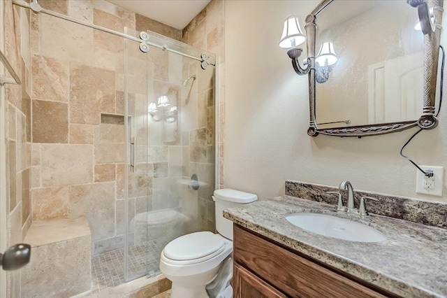 bathroom featuring vanity, toilet, and an enclosed shower