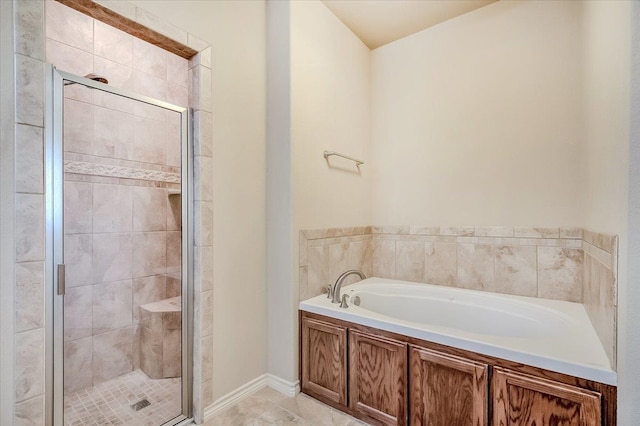 bathroom featuring tile patterned floors and independent shower and bath