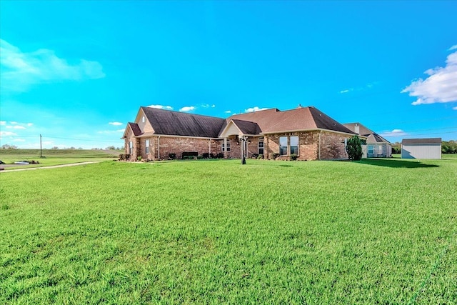 ranch-style home with an outdoor structure and a front yard