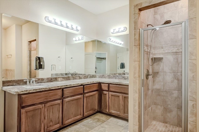 bathroom featuring vanity and a shower with door