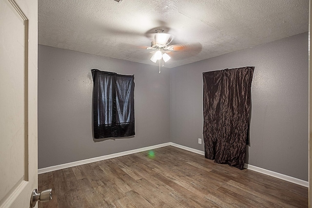 unfurnished room featuring ceiling fan, wood-type flooring, and a textured ceiling