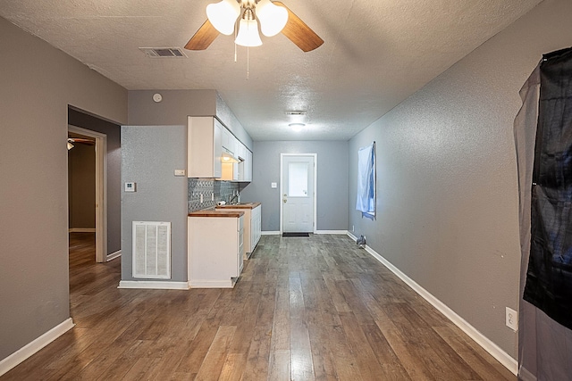 entrance foyer featuring hardwood / wood-style floors, a textured ceiling, ceiling fan, and sink