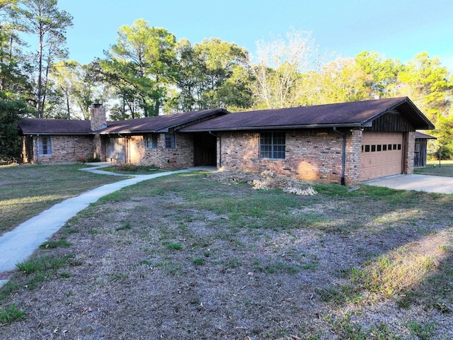 ranch-style house featuring a garage and a front lawn