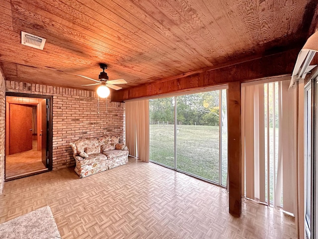 unfurnished sunroom featuring ceiling fan and wooden ceiling