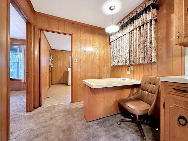 bar with wood walls, light colored carpet, and hanging light fixtures