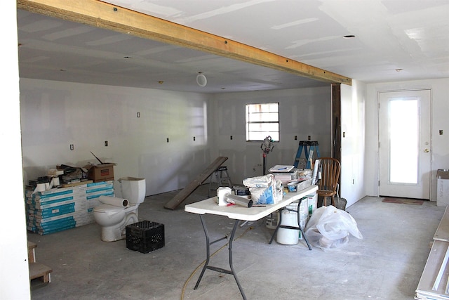 office space with unfinished concrete floors