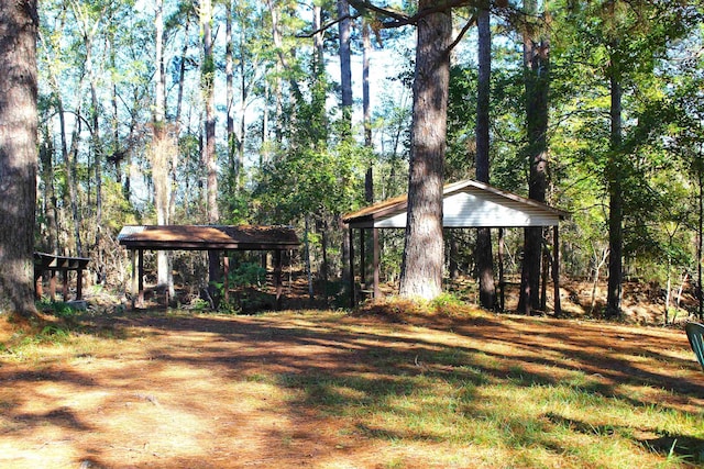 view of yard with a forest view and a gazebo