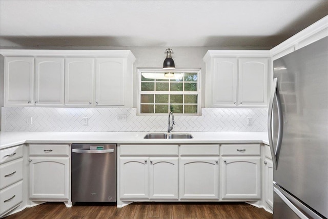 16 Briarcliff Ln, Lumberton, TX 77657 - kitchen with appliances with stainless steel finishes, white cabinetry, decorative backsplash, dark wood-type flooring, and light countertops