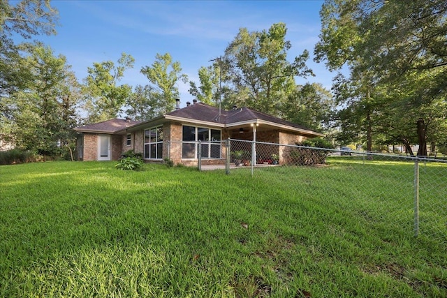 16 Briarcliff Ln, Lumberton, TX 77657 - rear view of house with a fenced backyard and brick siding