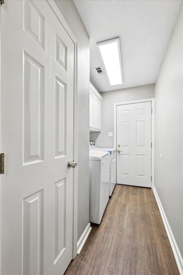 16 Briarcliff Ln, Lumberton, TX 77657 - laundry room with cabinet space, washer and dryer, and dark wood-style floors