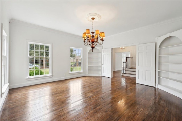 unfurnished room featuring baseboards, dark wood-style floors, stairway, built in shelves, and a notable chandelier