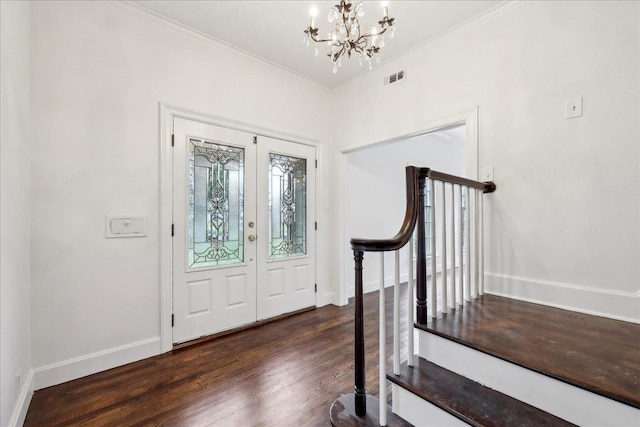 entrance foyer featuring visible vents, baseboards, stairs, dark wood-style floors, and an inviting chandelier